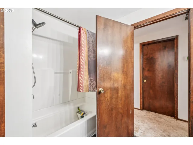 a bathroom with a bathtub and a shower