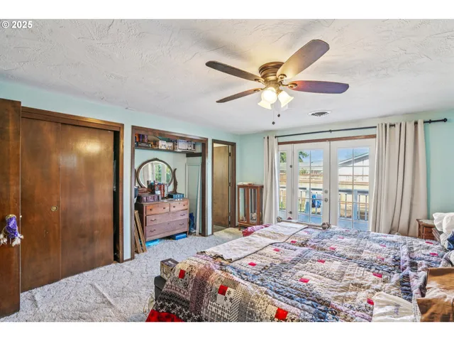 a bedroom with a bed and a large mirror with a chandelier