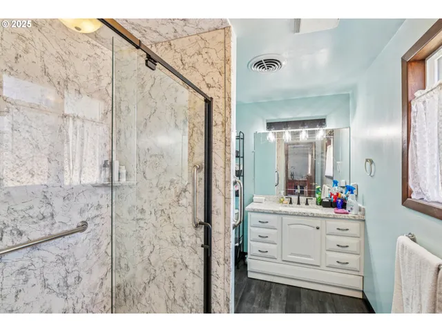 a bathroom with a sink mirror and cabinets