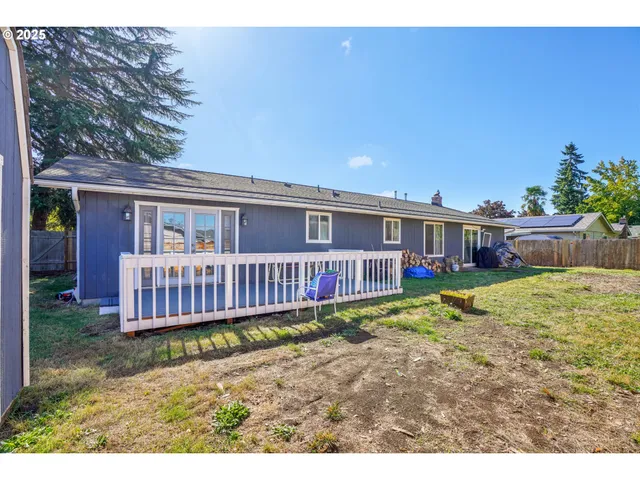a view of an house with backyard and porch