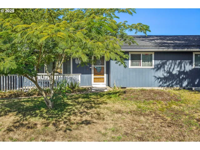 a yellow house with trees in front of it