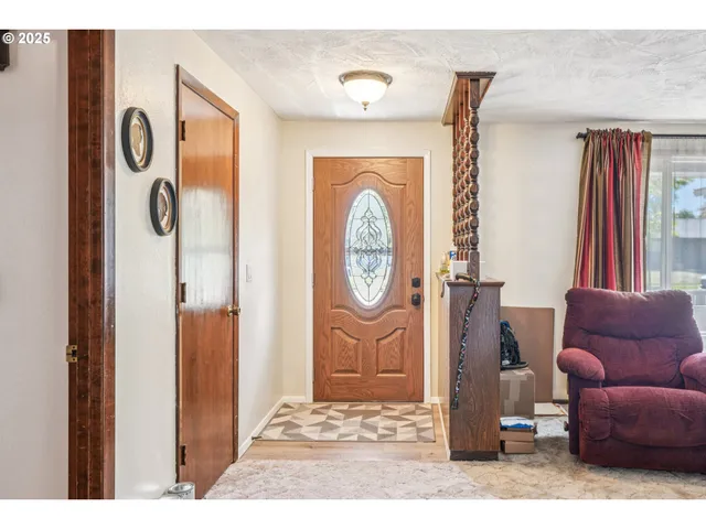 a view of living room filled with furniture and a window