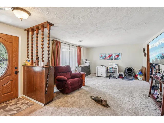 a living room with furniture a flat screen tv and a large window