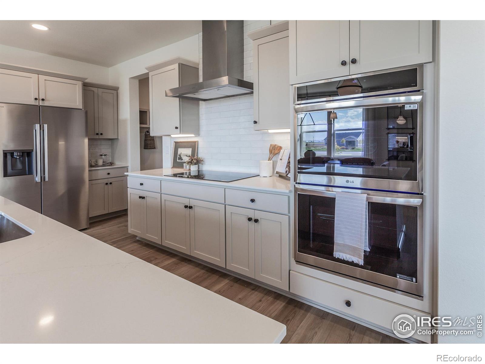 6079 Red Barn Road Fort Collins, CO 80528 - Photo 12 of 41 a kitchen with stainless steel appliances granite countertop a stove a sink and a refrigerator