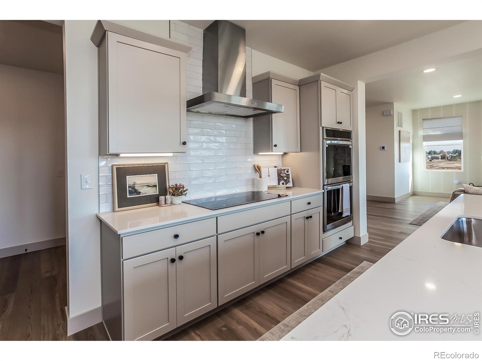 6079 Red Barn Road Fort Collins, CO 80528 - Photo 14 of 41 a kitchen with cabinets and wooden floor