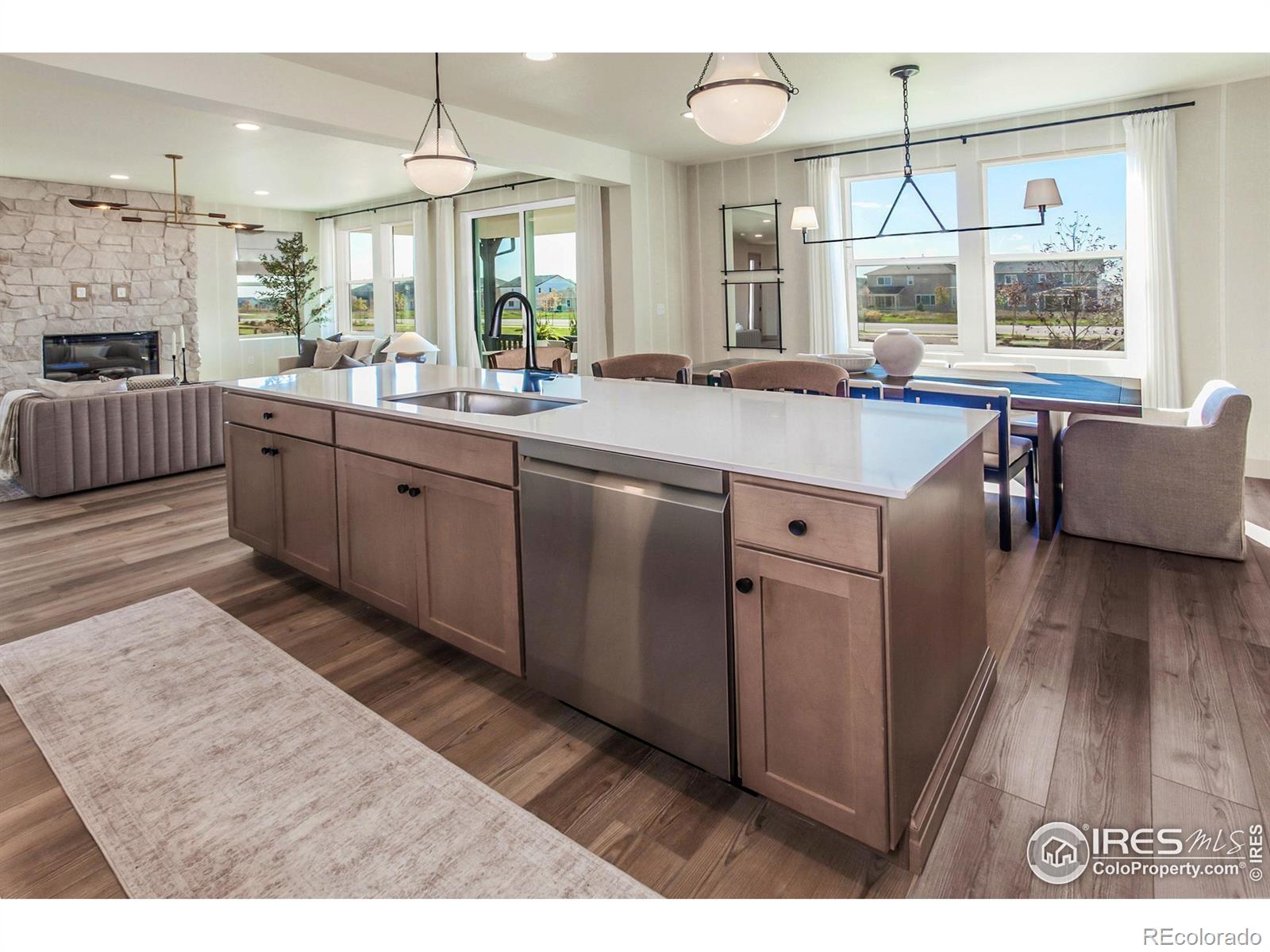 6079 Red Barn Road Fort Collins, CO 80528 - Photo 16 of 41 a kitchen with stainless steel appliances granite countertop a sink stove and wooden floor
