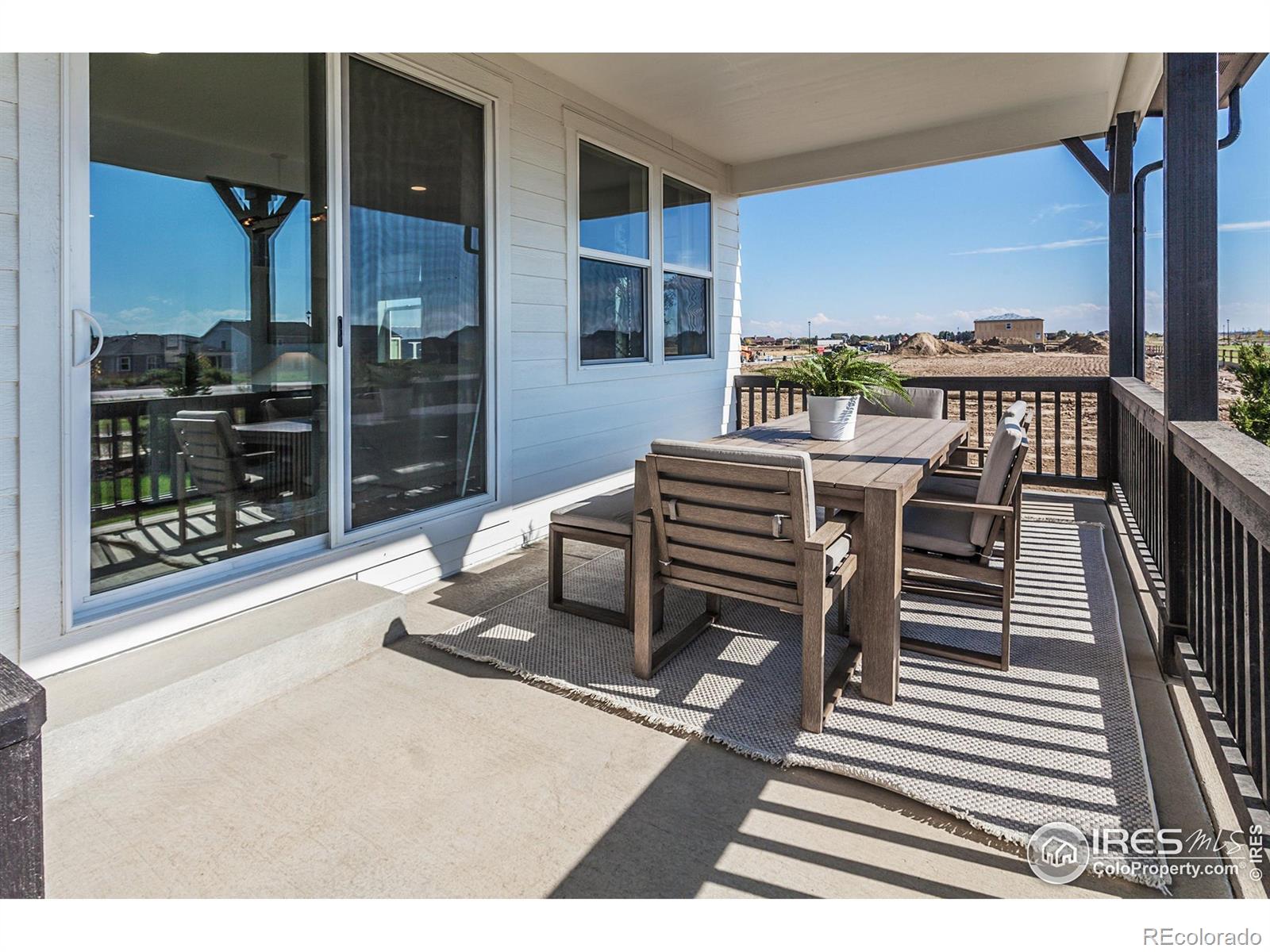 6079 Red Barn Road Fort Collins, CO 80528 - Photo 40 of 41 a dining room with furniture and a floor to ceiling window