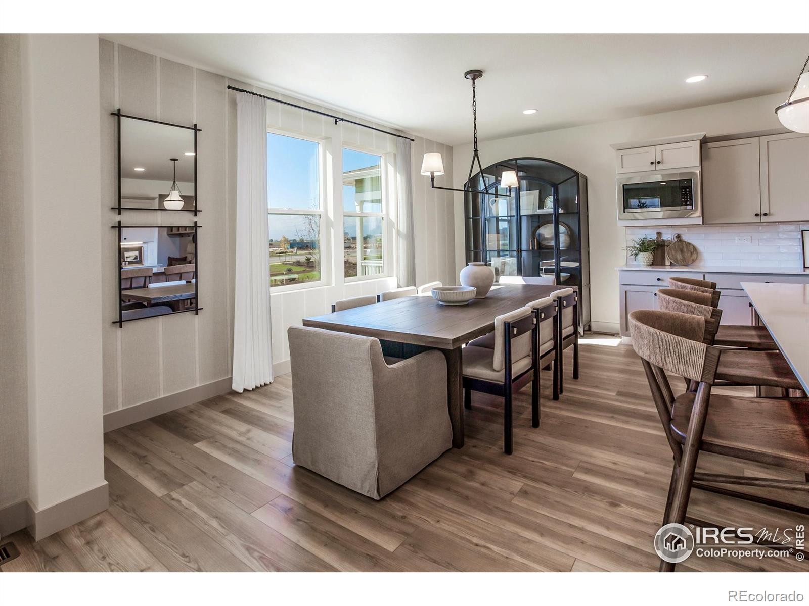 6079 Red Barn Road Fort Collins, CO 80528 - Photo 10 of 41 a view of a dining room with furniture window and wooden floor