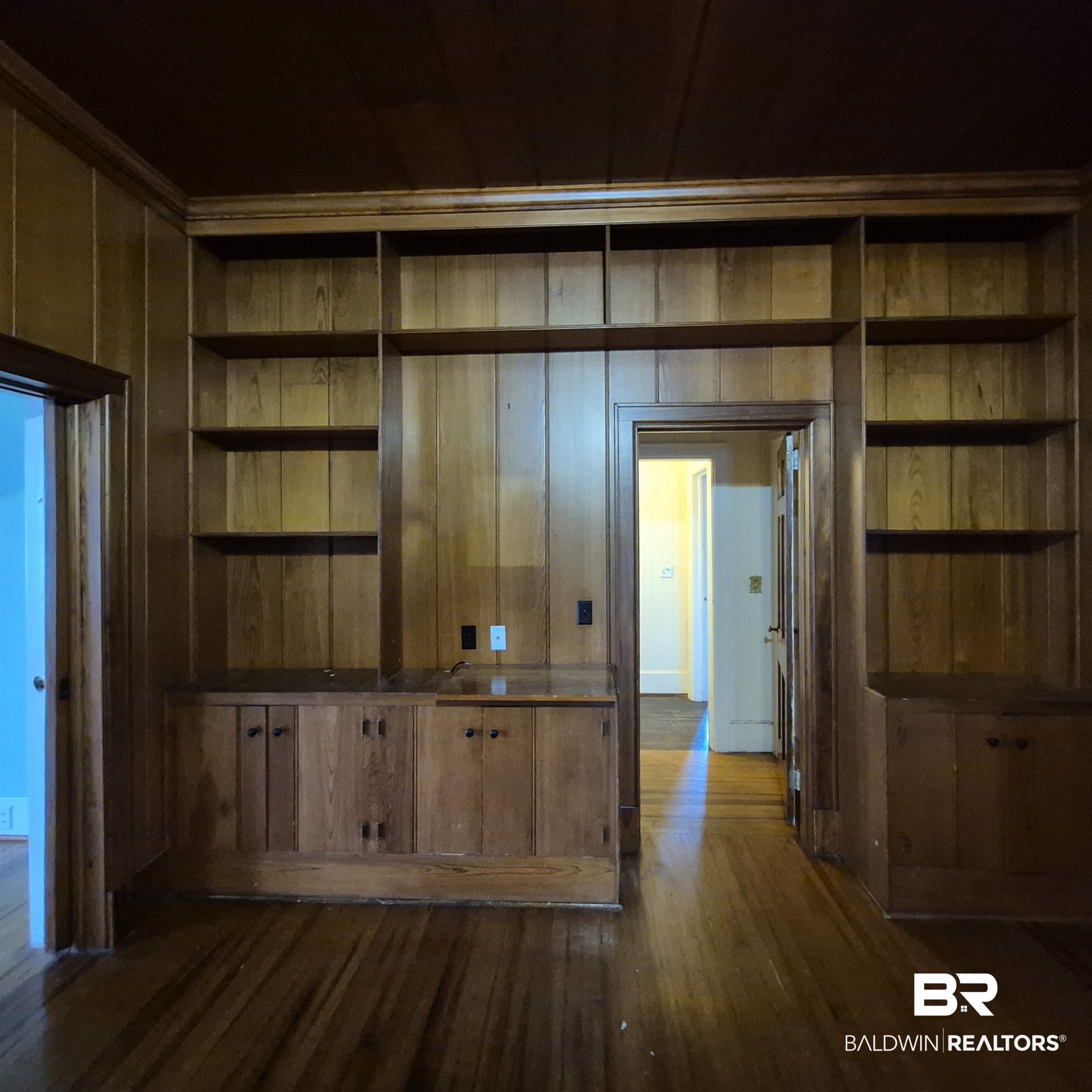 308 Rural Street Evergreen, AL 36401 - Photo 7 of 40 Interior space featuring dark wood-type flooring, wooden walls, and built in features