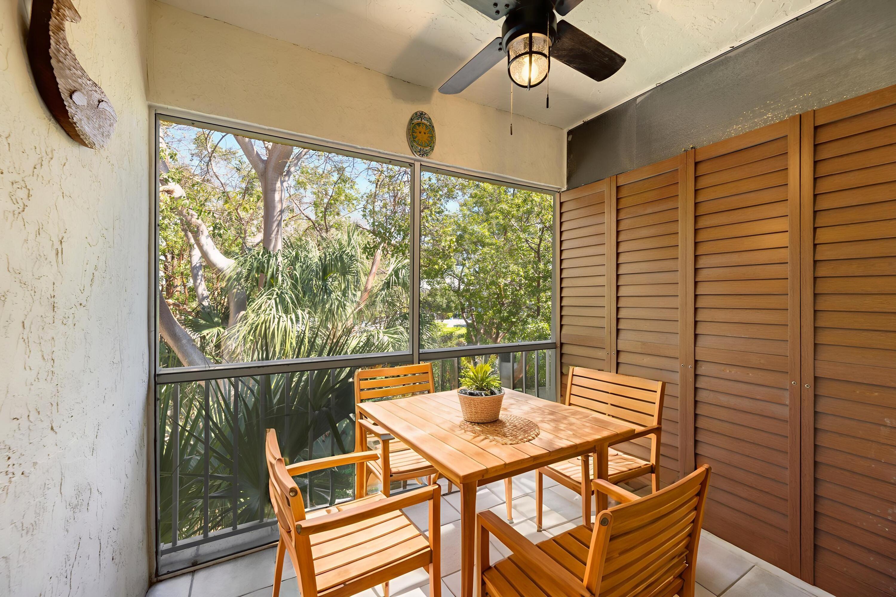 98202 Windward Avenue, Unit CONDO W/ 30 FT BOAT SLIP Key Largo, FL 33037 - Photo 16 of 36 a view of a dining room with furniture window and outside view
