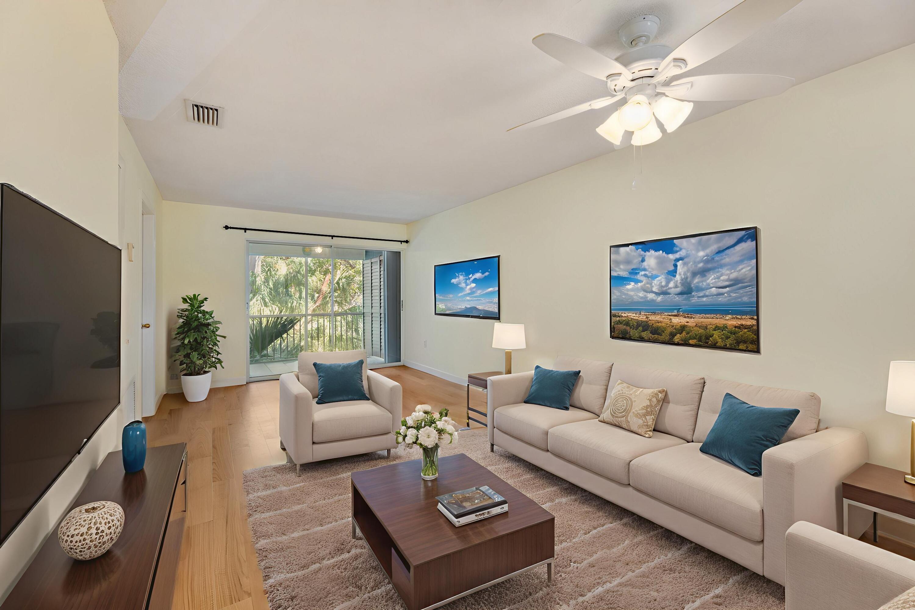 98202 Windward Avenue, Unit CONDO W/ 30 FT BOAT SLIP Key Largo, FL 33037 - Photo 2 of 36 a living room with furniture a rug and a flat screen tv