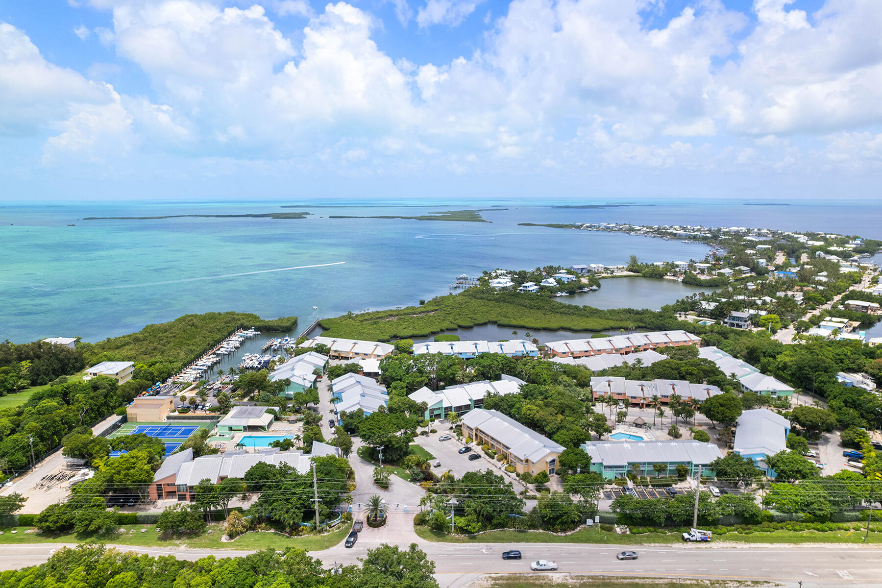 98202 Windward Avenue, Unit CONDO W/ 30 FT BOAT SLIP Key Largo, FL 33037 - Photo 21 of 36 an aerial view of residential building with outdoor space