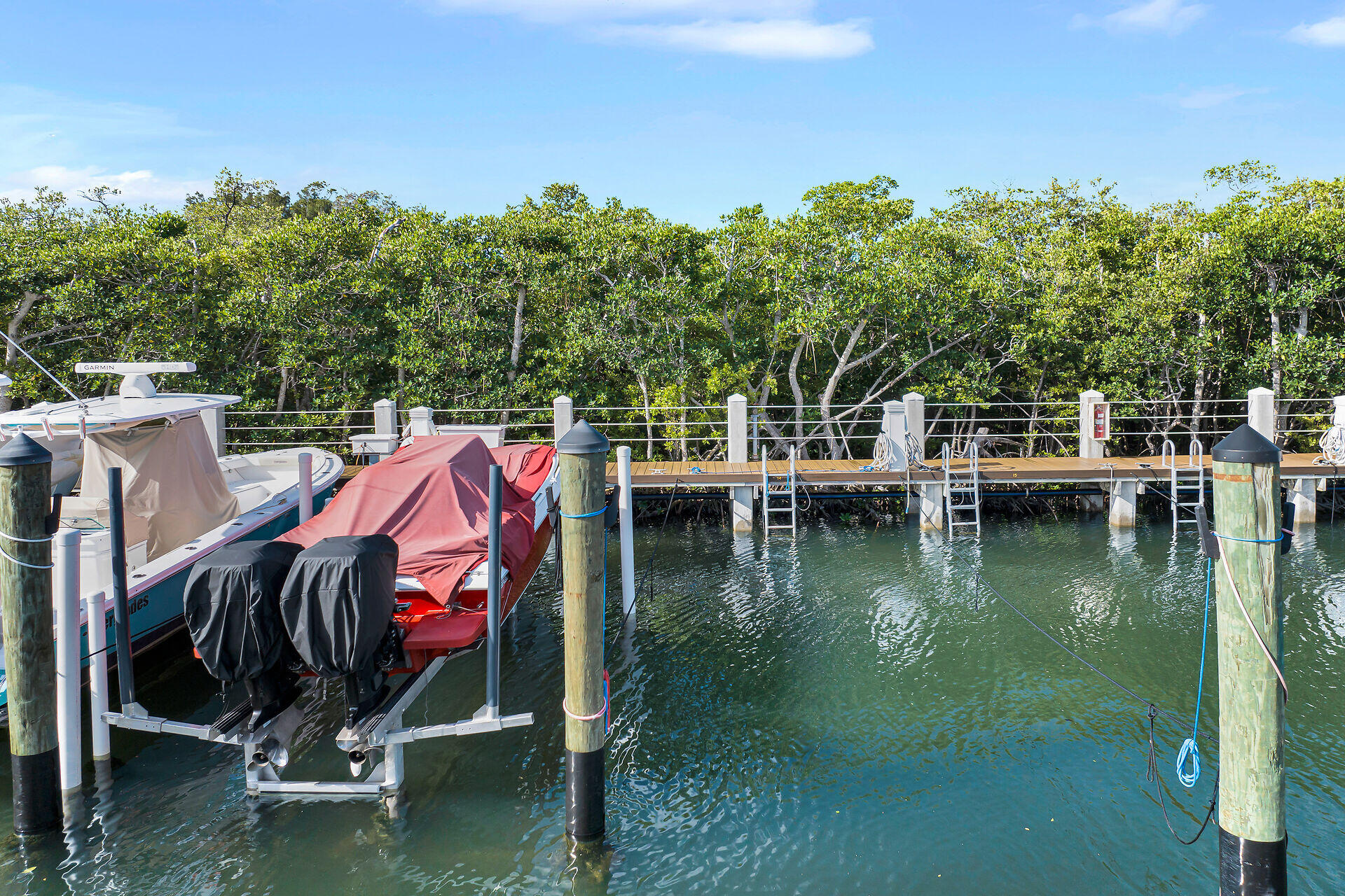 98202 Windward Avenue, Unit CONDO W/ 30 FT BOAT SLIP Key Largo, FL 33037 - Photo 21 of 36 a view of a lake with boats