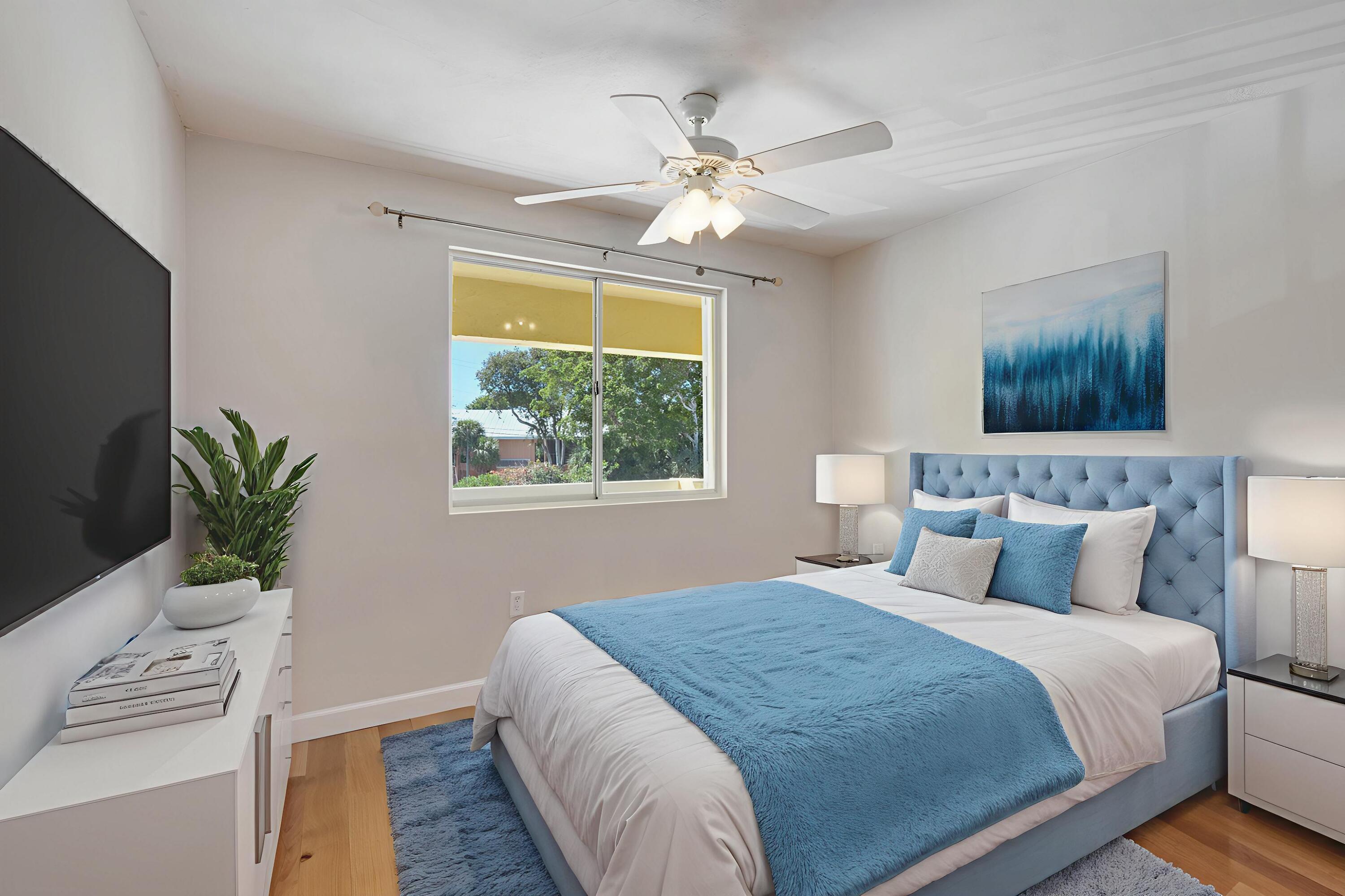 98202 Windward Avenue, Unit CONDO W/ 30 FT BOAT SLIP Key Largo, FL 33037 - Photo 32 of 36 a bedroom with a large bed and a window