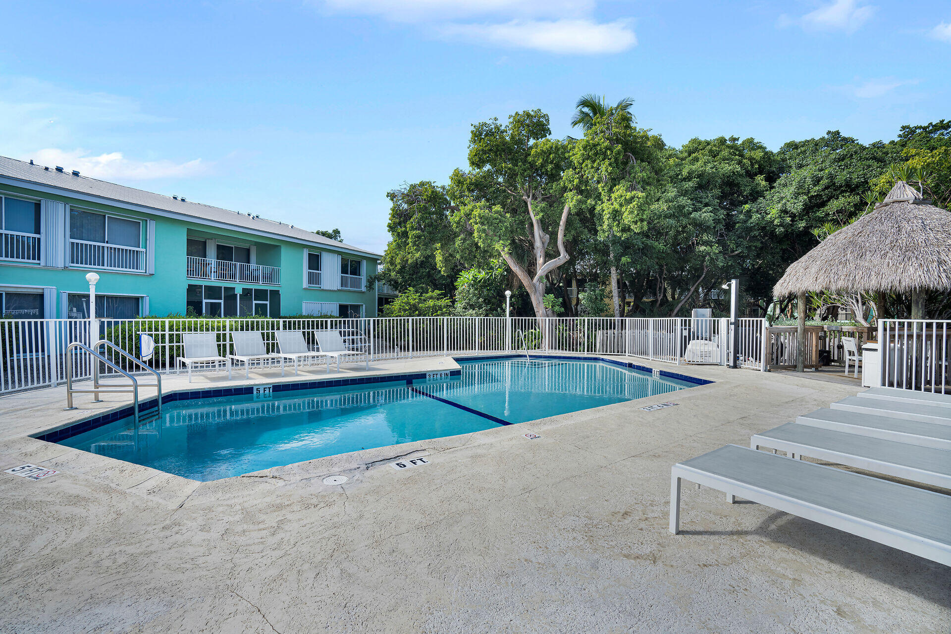 98202 Windward Avenue, Unit CONDO W/ 30 FT BOAT SLIP Key Largo, FL 33037 - Photo 34 of 36 swimming pool view with a outdoor seating