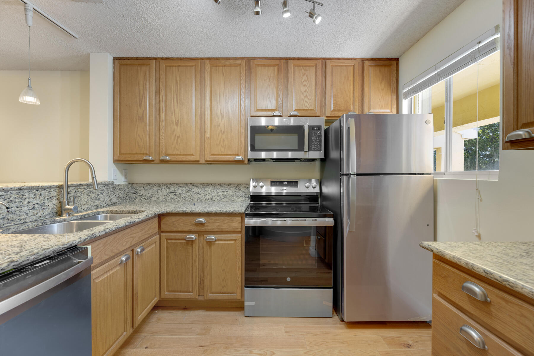 98202 Windward Avenue, Unit CONDO W/ 30 FT BOAT SLIP Key Largo, FL 33037 - Photo 5 of 36 a kitchen with a sink stove and refrigerator