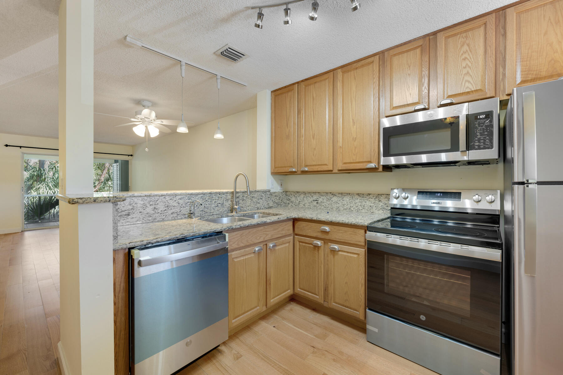 98202 Windward Avenue, Unit CONDO W/ 30 FT BOAT SLIP Key Largo, FL 33037 - Photo 6 of 36 a kitchen with a stove and a microwave