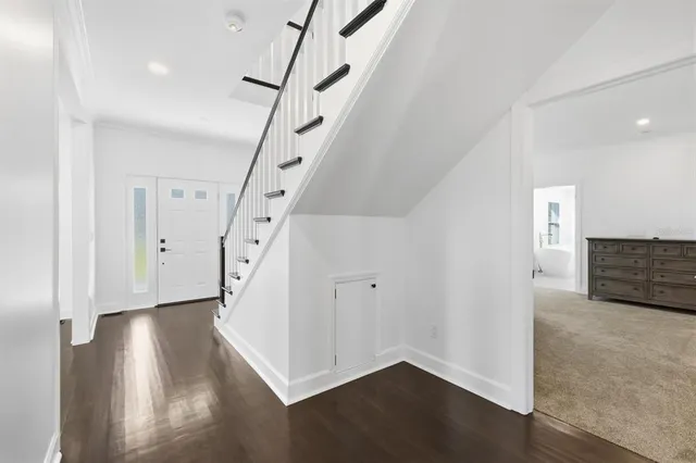 a view of an entryway with wooden floor