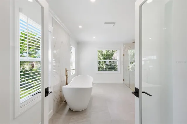 an aerial view of residential houses with outdoor space and parking