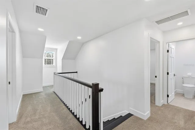 an aerial view of residential houses with outdoor space and ocean view