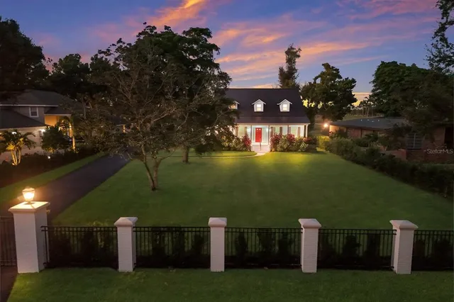 a view of a house with swimming pool and a yard