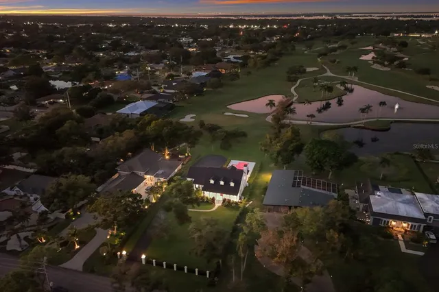 a view of a room with wooden floor and windows