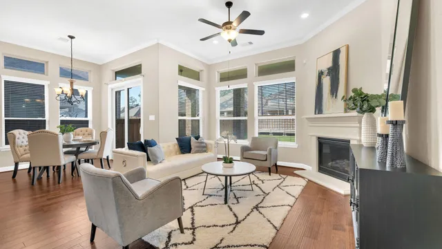 a living room with furniture a fireplace and a chandelier