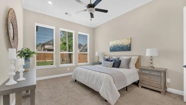 a bedroom with a large bed chandelier and a window