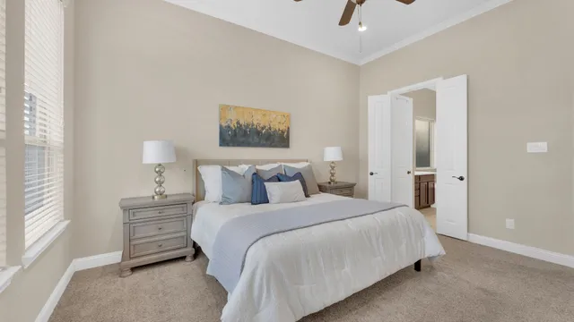 a bedroom with a bed and a painting on the wall