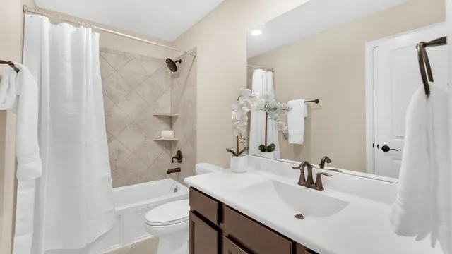 a bathroom with a sink toilet tub and shower