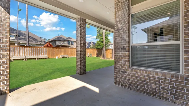 a view of a yard with a house in the background