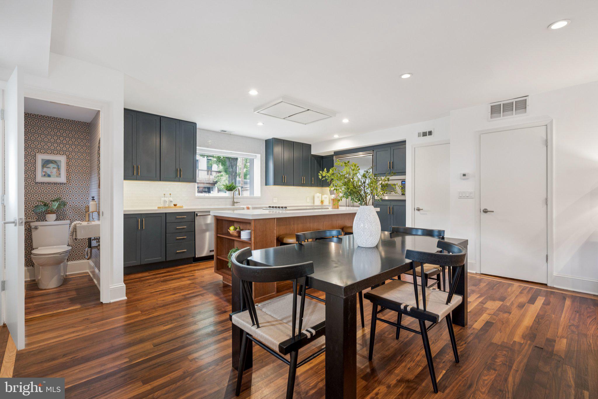 1 Derby Lane Washington, DC 20003 - Photo 6 of 33 a kitchen with stainless steel appliances kitchen island granite countertop wooden floor and white cabinets