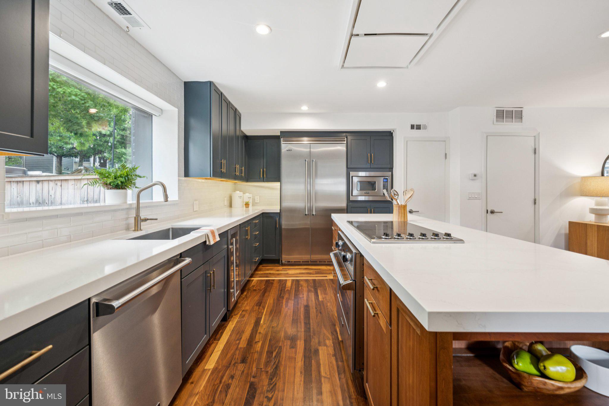 1 Derby Lane Washington, DC 20003 - Photo 10 of 33 a kitchen with kitchen island a sink stove and wooden floor