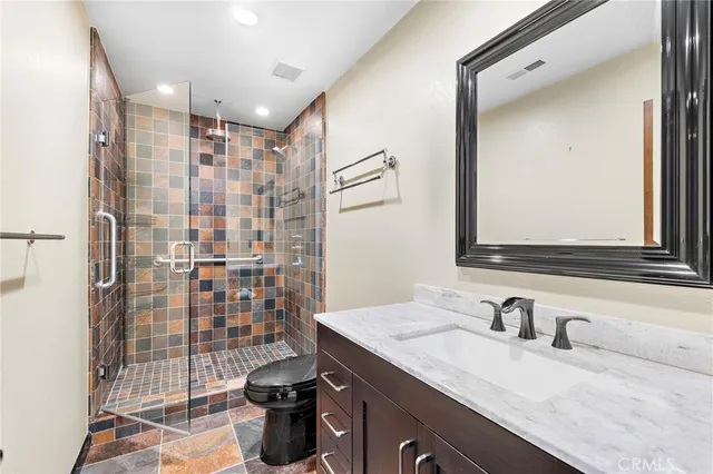 a bathroom with a sink double vanity and a shower
