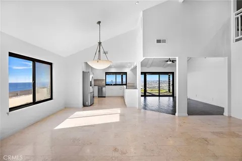 a view of an empty room with window and cabinet