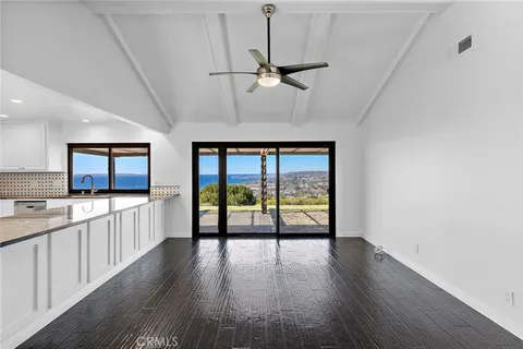 a open kitchen with a large window a oven and a counter space