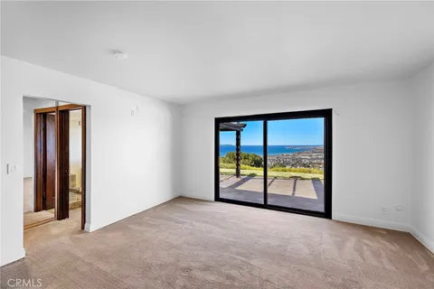 an empty room with sliding door and mountain view