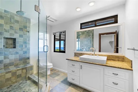 a bathroom with a granite countertop sink mirror and double