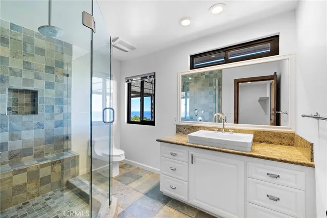 a bathroom with a granite countertop sink mirror and double