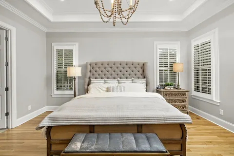a bed sitting in a bedroom next to a window