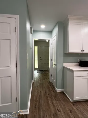 a view of hallway with wooden floor