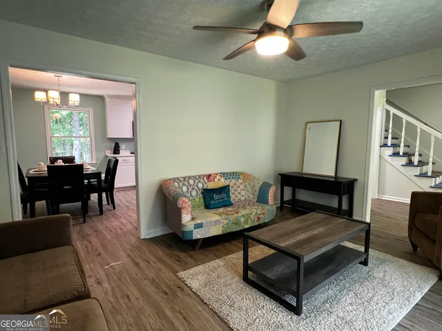 a living room with furniture and a chandelier