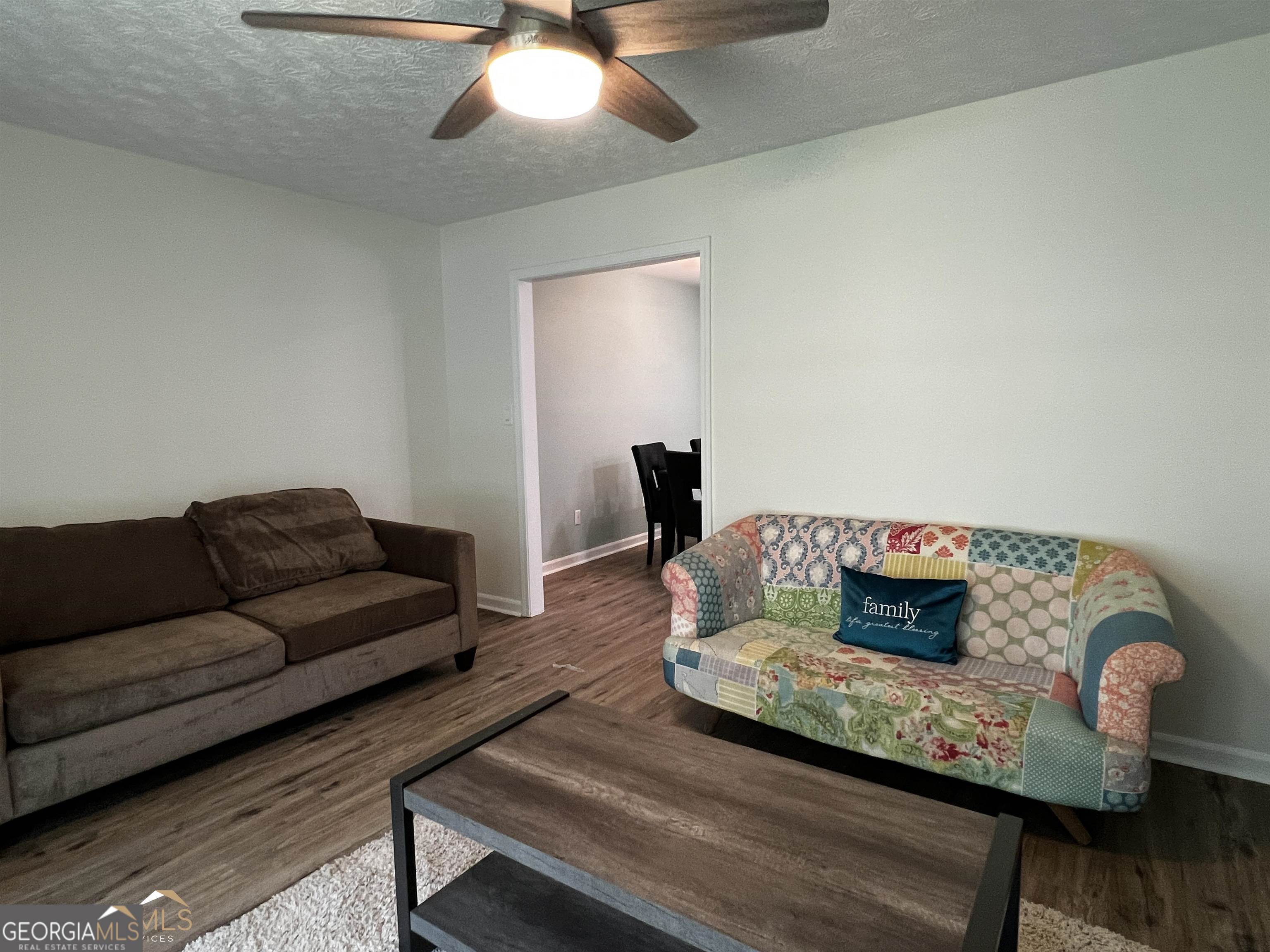 208 Swanson Ridge Peachtree City, GA 30269 - Photo 22 of 40 a living room with furniture and a wooden floor