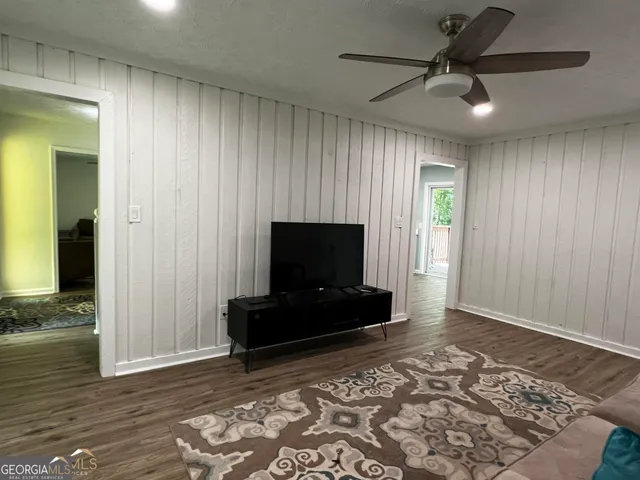 a living room with furniture and a flat screen tv