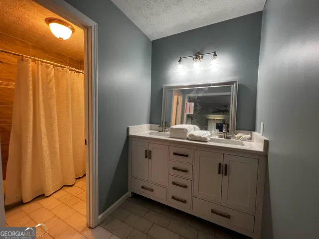 a bathroom with a sink and mirror