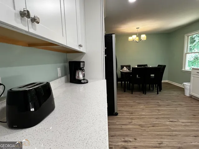a view of a dining room with furniture and window