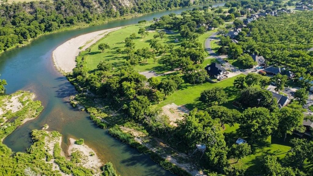 8820 Ravenswood Road Granbury, TX 76049 - Photo 1 of 17 an aerial view of lake residential house with outdoor space and trees