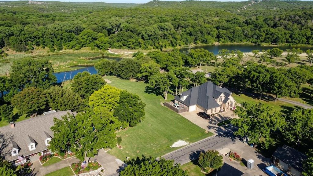8820 Ravenswood Road Granbury, TX 76049 - Photo 6 of 17 an aerial view of residential houses with outdoor space and trees