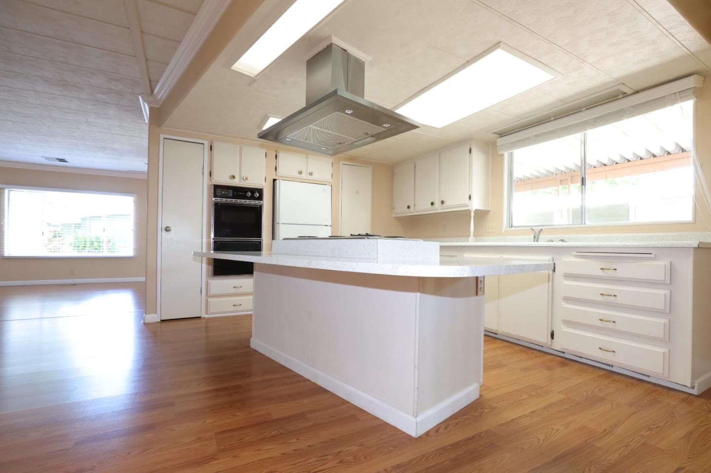 61 Quail Hollow Drive, Unit 61 San Jose, CA 95128 - Photo 17 of 36 a large kitchen with stainless steel appliances a large counter top a sink a window and cabinets