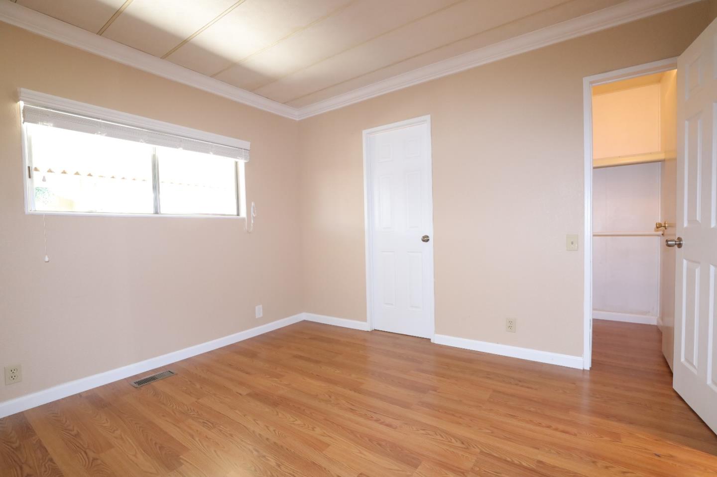 61 Quail Hollow Drive, Unit 61 San Jose, CA 95128 - Photo 20 of 36 a view of empty room with wooden floor and fan